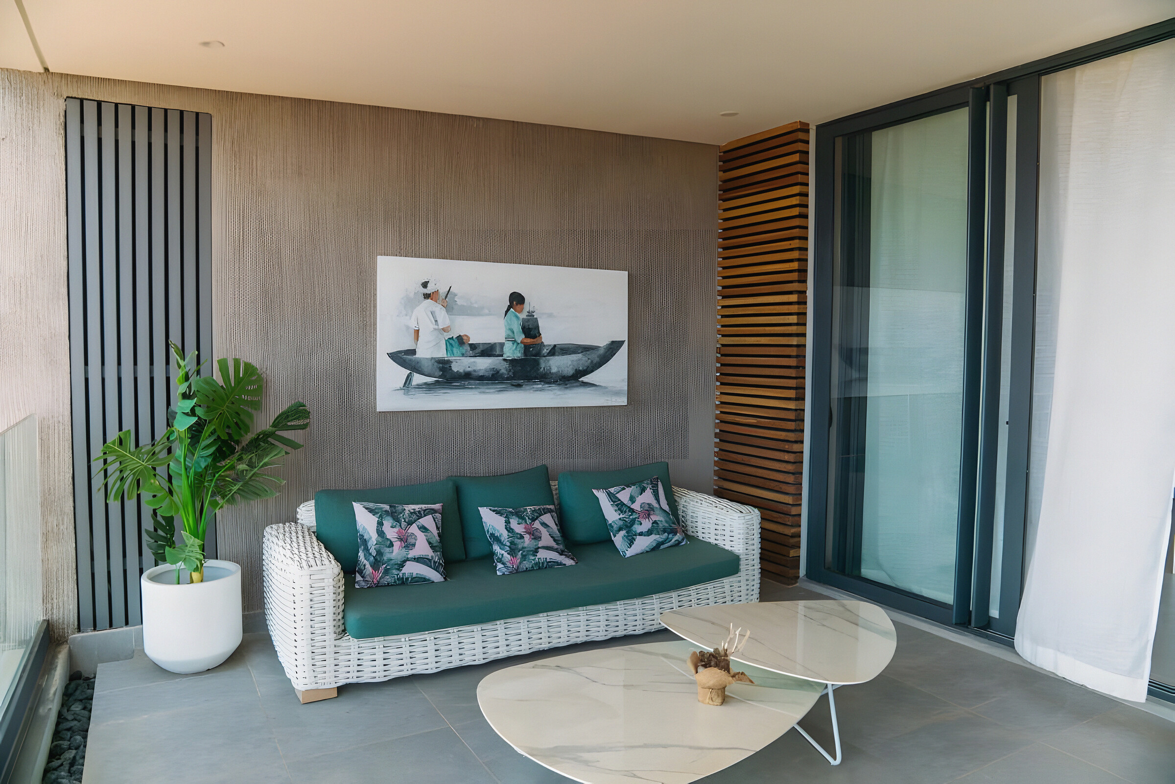 The covered outdoor seating area with a sofa beside the sliding doors
