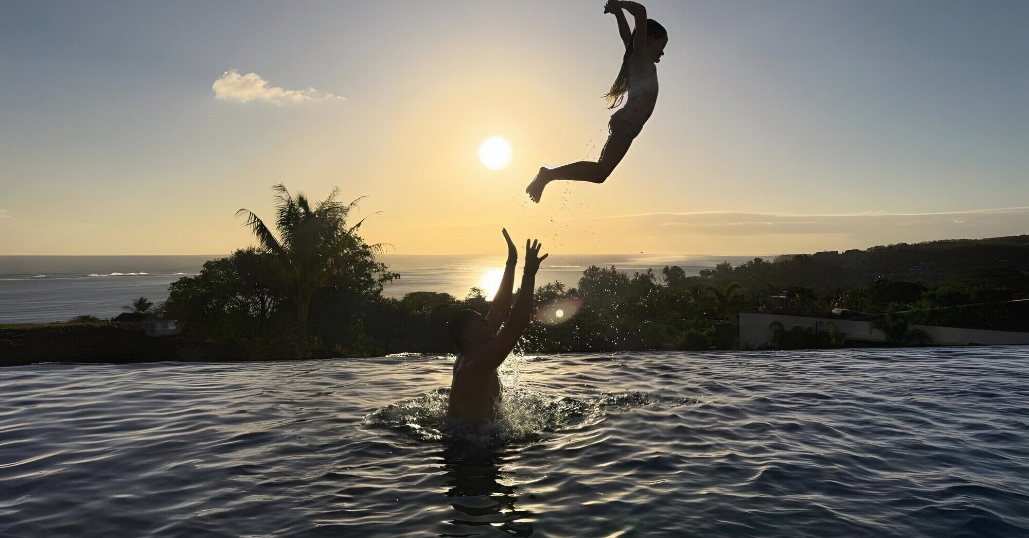 Sunset from the pool at The View, the sun low over the sea