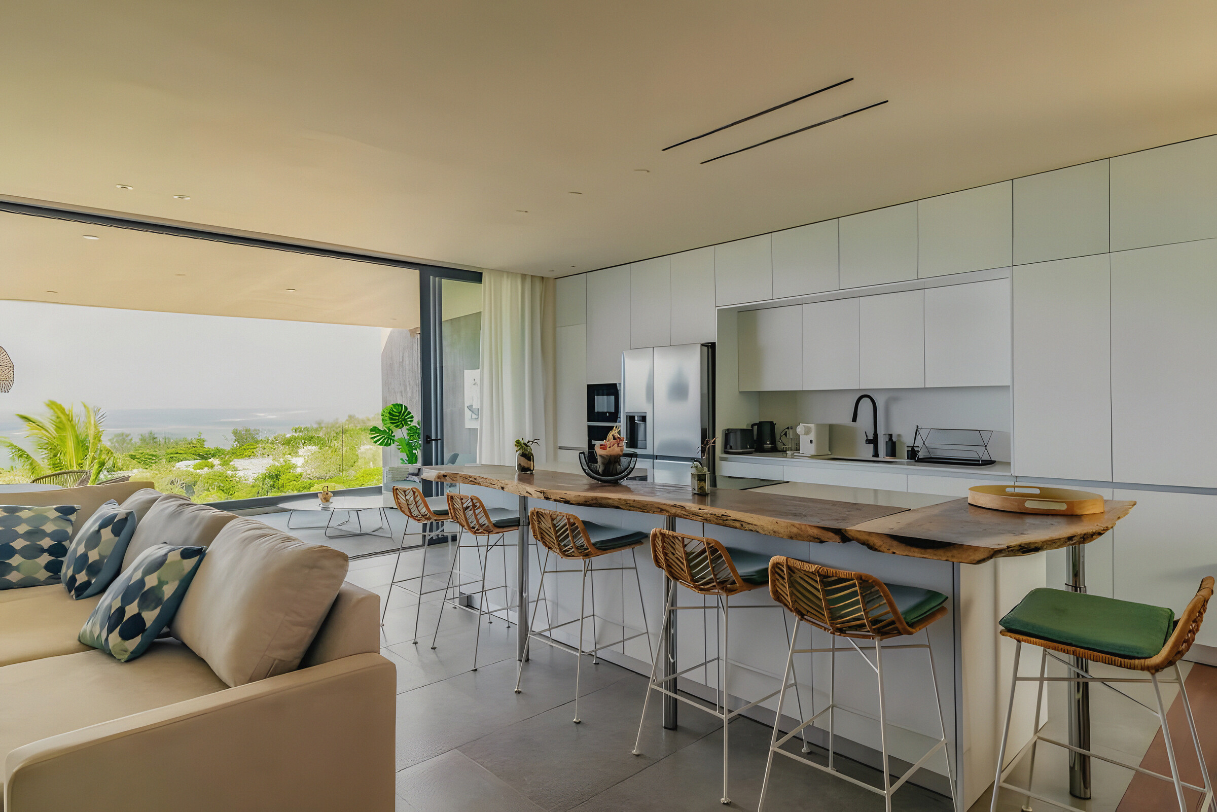 The kitchen and its live-edge timber breakfast counter, open to the living room